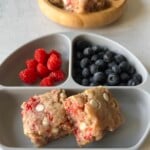 Raspberry white chocolate blondies served with berries.