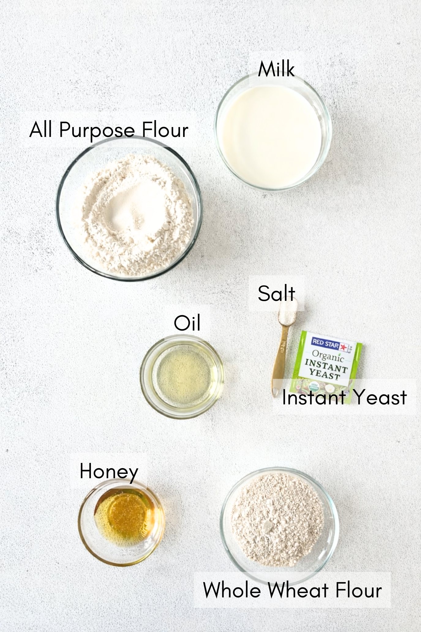 Ingredients to make honey wheat sandwich bread loaf.