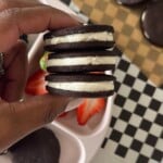 Homemade oreo cookies served with berries.