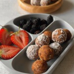 Carrot cake bliss balls served with berries.