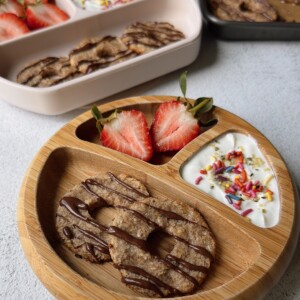 Coconut banana cookies served with yogurt and strawberries.