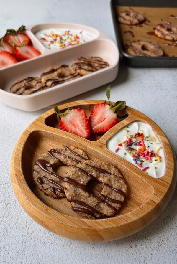 Coconut banana cookies served with yogurt and strawberries.
