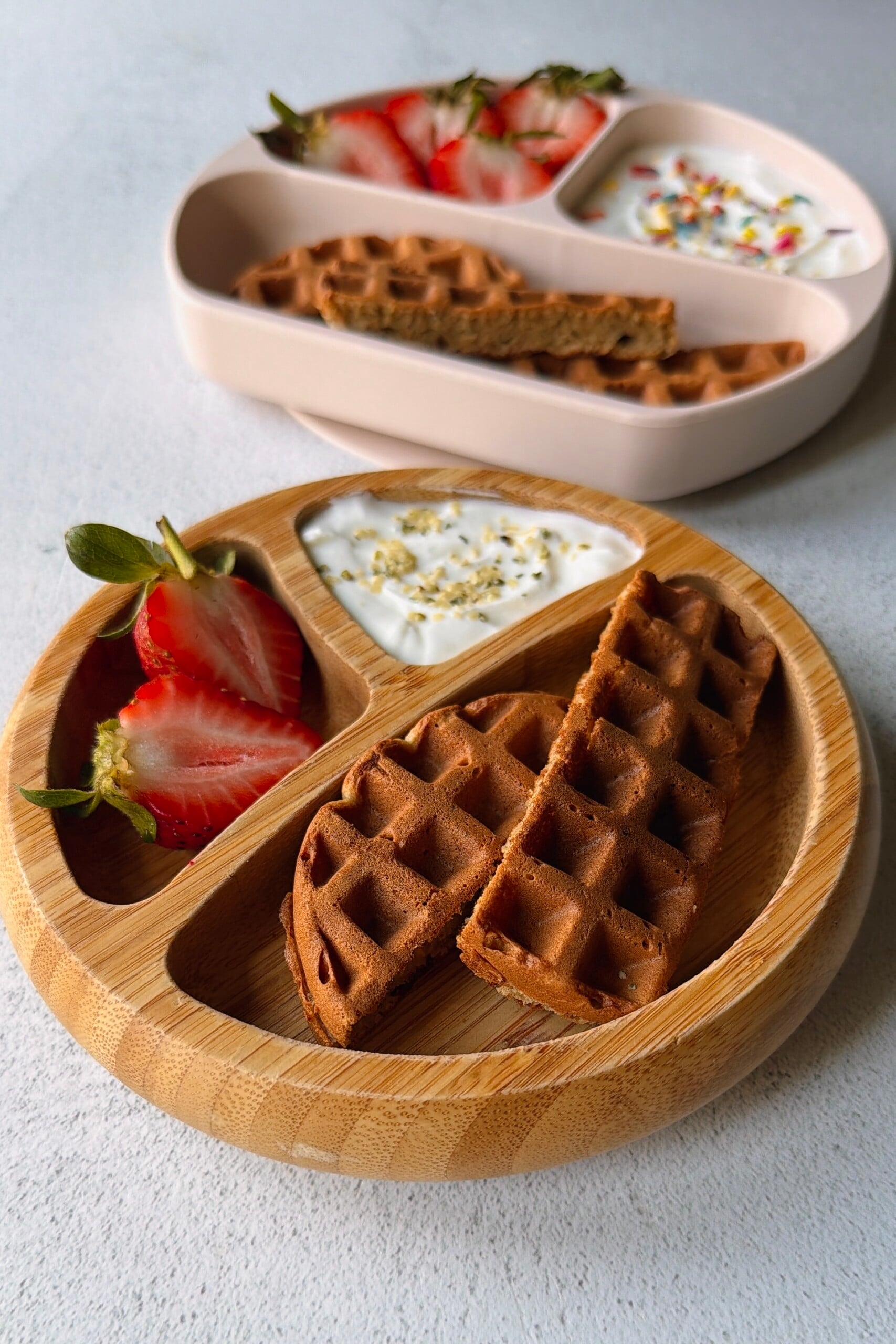Banana oat waffles served with berries and yogurt.