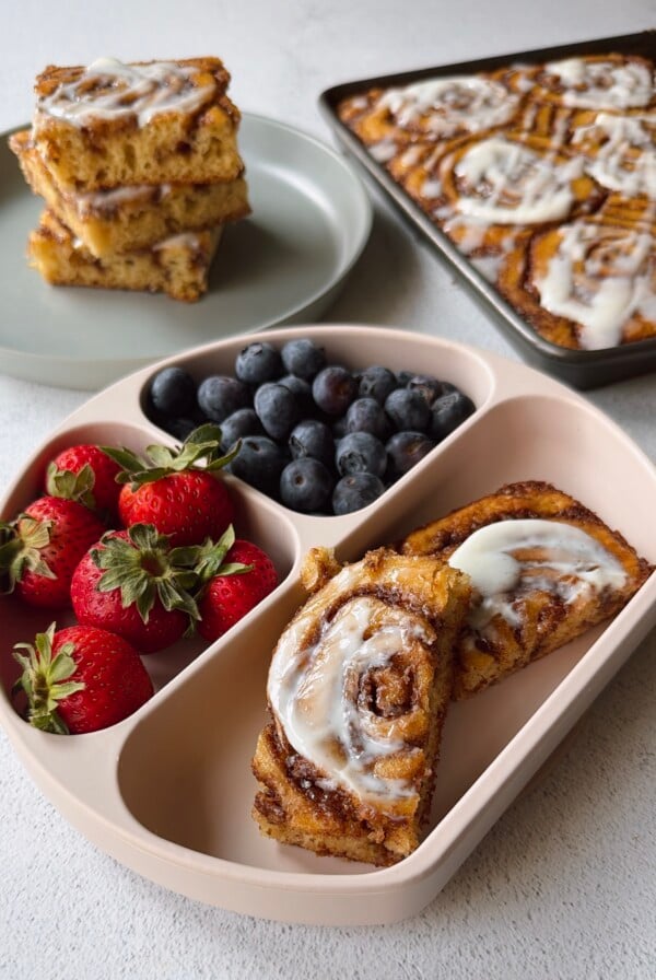 Cinnamon roll pancakes served with berries.