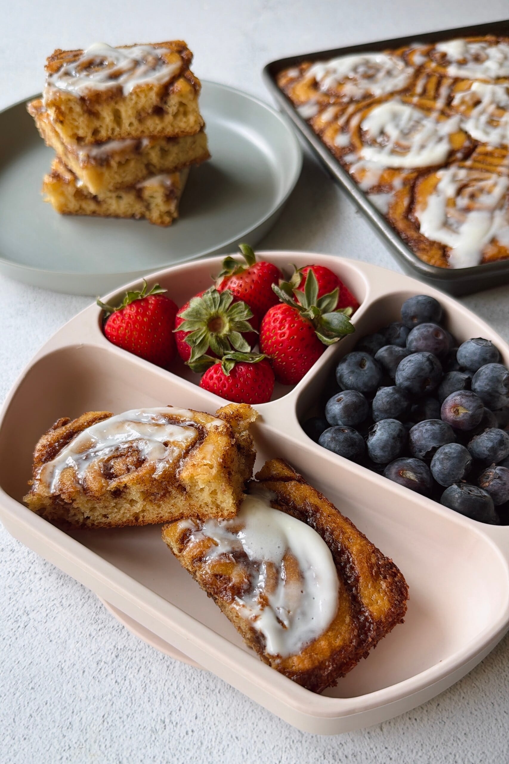 Cinnamon roll pancakes served with berries.