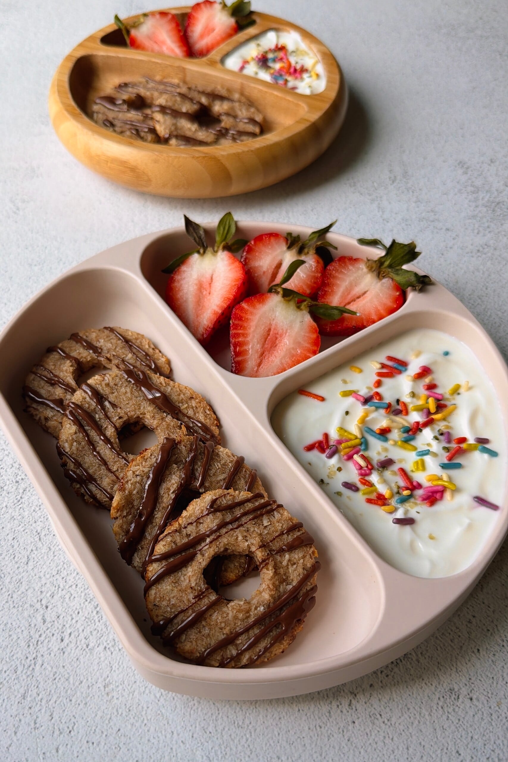 Coconut banana cookies served with yogurt and strawberries.