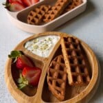 Banana oat waffles served with berries and yogurt.