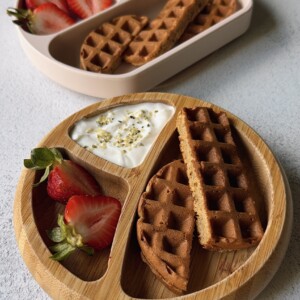 Banana oat waffles served with berries and yogurt.