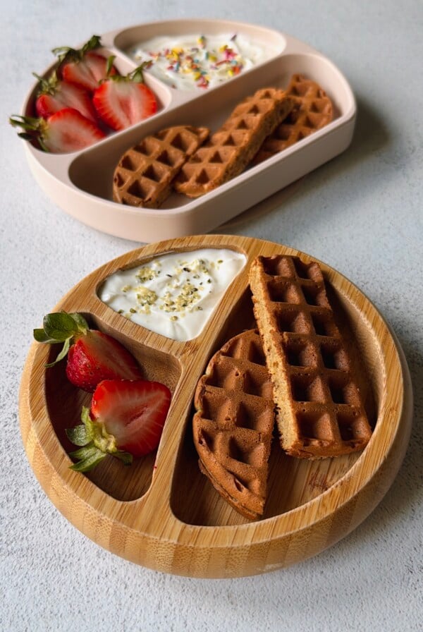Banana oat waffles served with berries and yogurt.