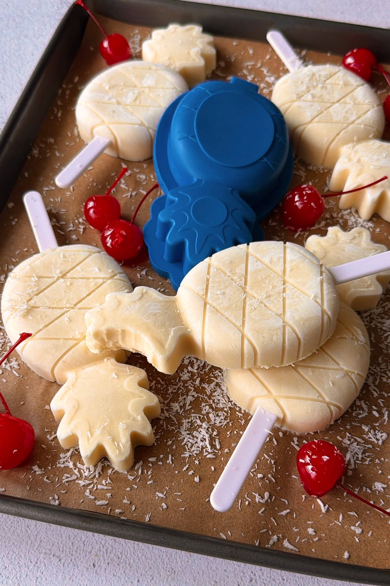 Pina colada popsicles on a tray.