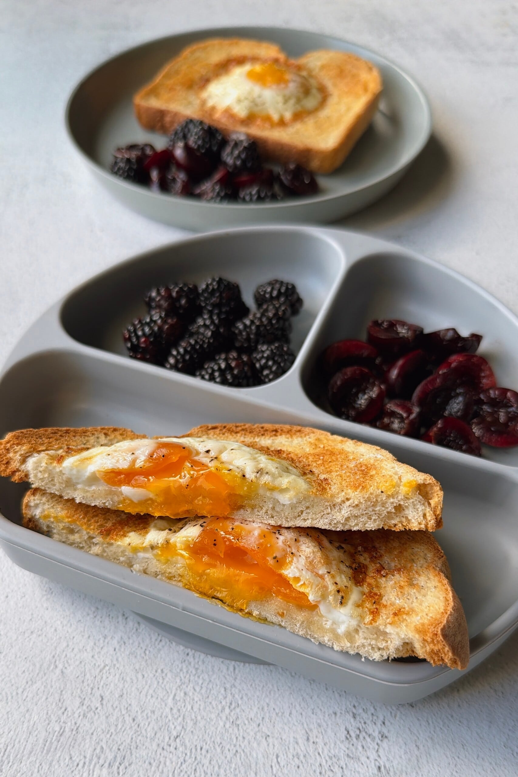 Air fryer egg toast served with blackberries and cherries.