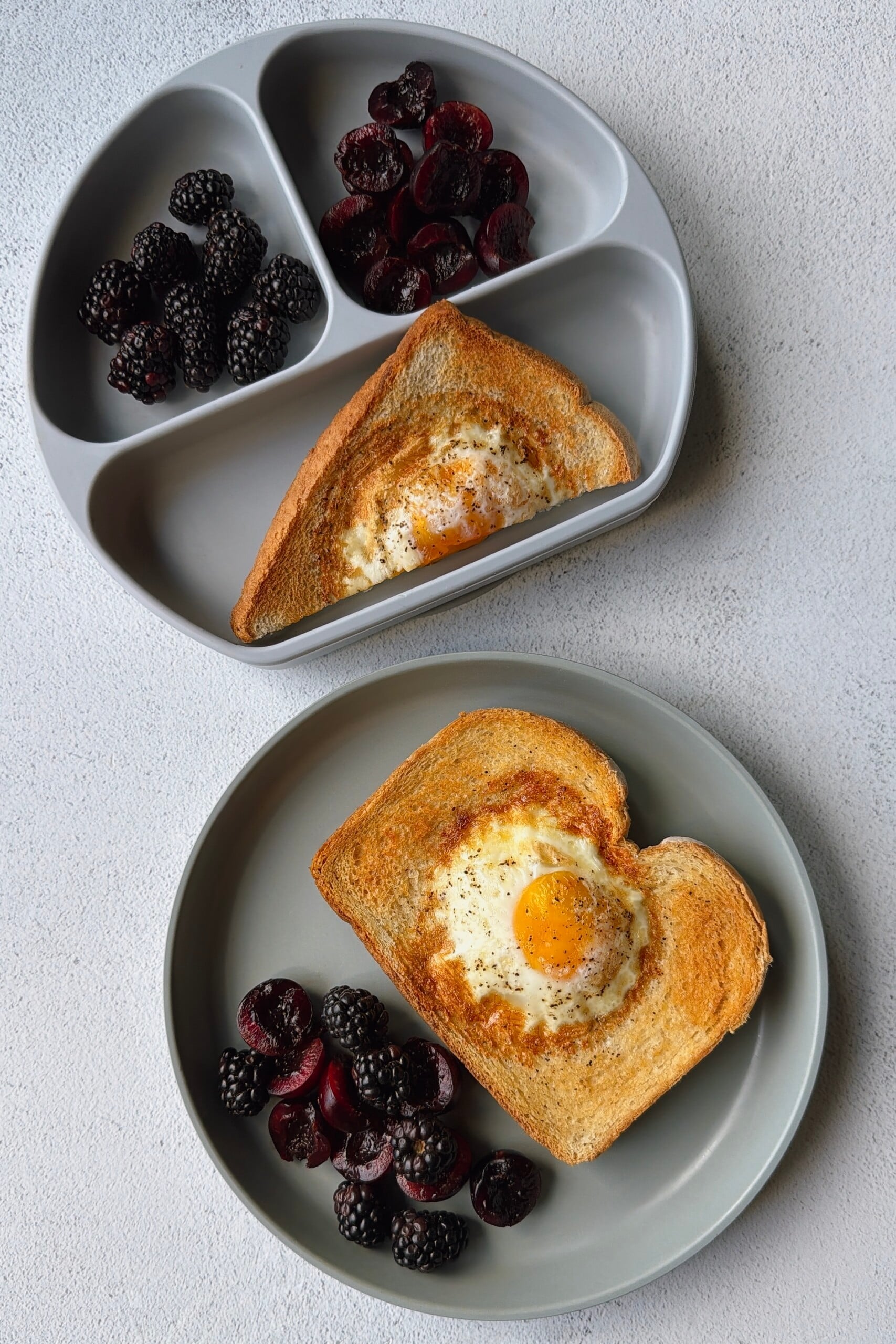 Air fryer egg toast served with blackberries and cherries.