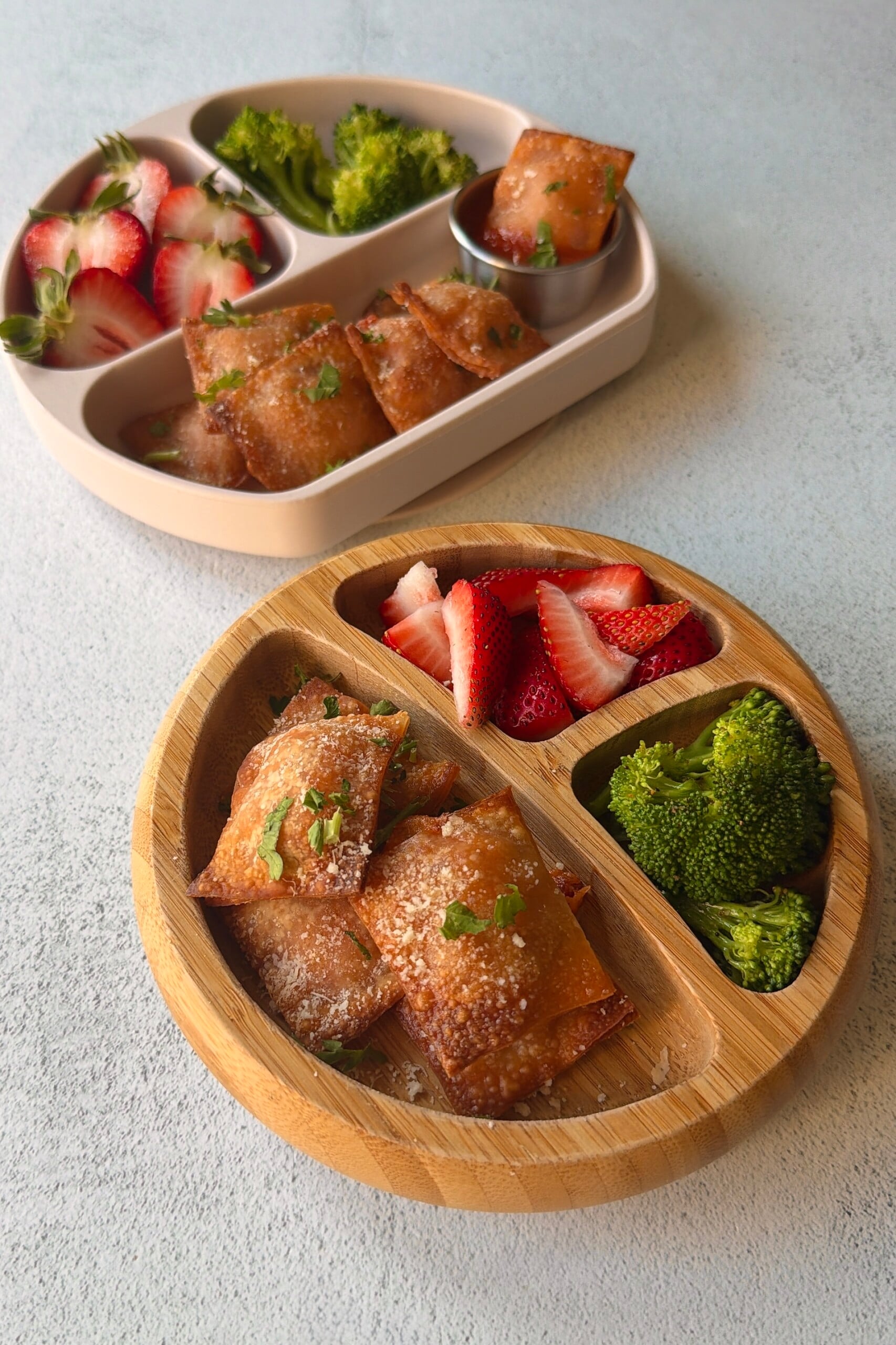 Homemade pizza rolls served with strawberries and broccoli.