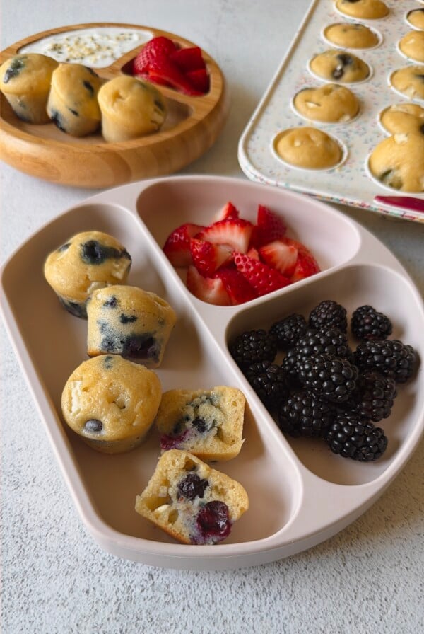 Blueberry and white chocolate muffins served with berries and yogurt.