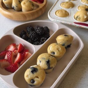 Blueberry and white chocolate muffins served with berries and yogurt.