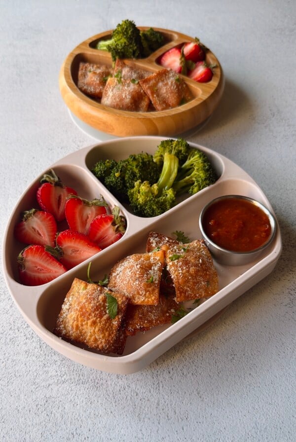 Homemade pizza rolls served with strawberries and broccoli.