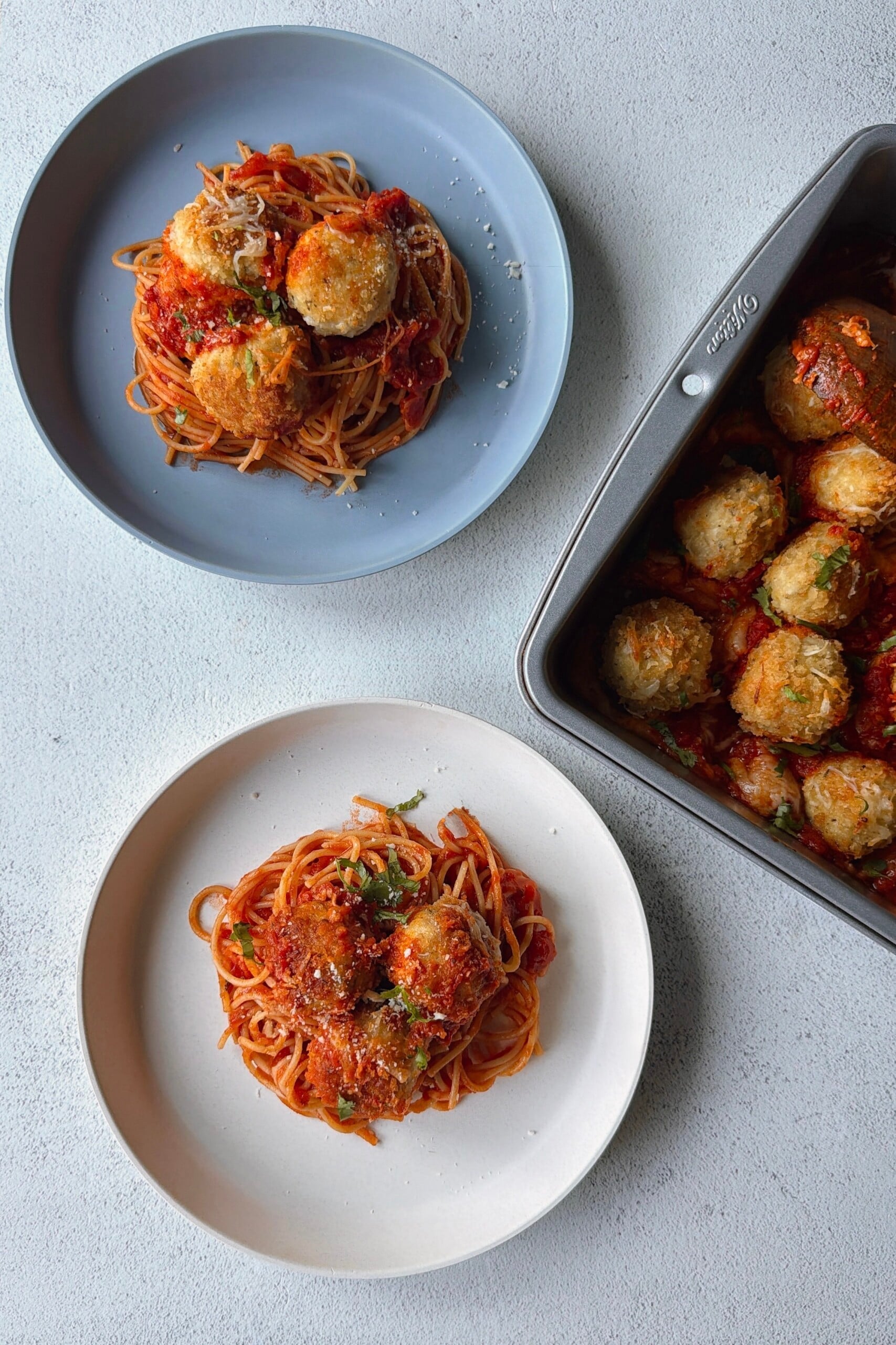 Chicken parm meatballs served with spaghetti.