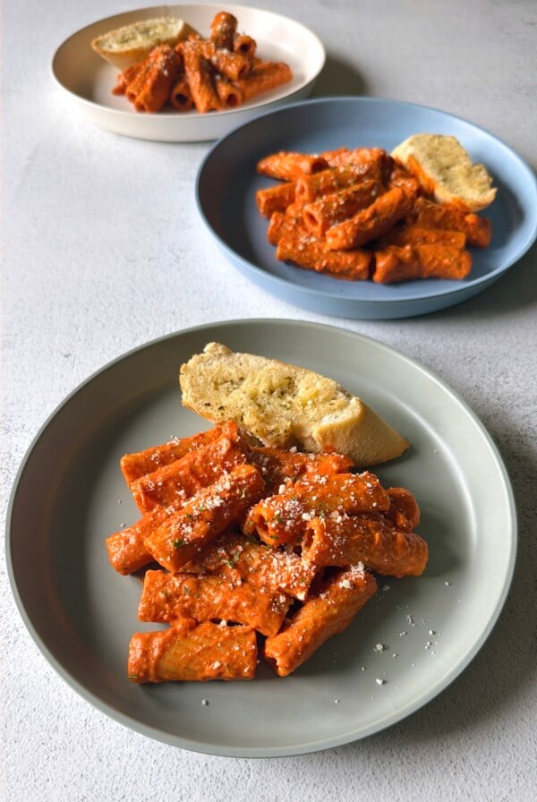 Creamy tomato pasta served with garlic bread.