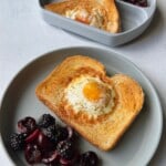 Air fryer egg toast served with blackberries and cherries.