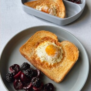 Air fryer egg toast served with blackberries and cherries.