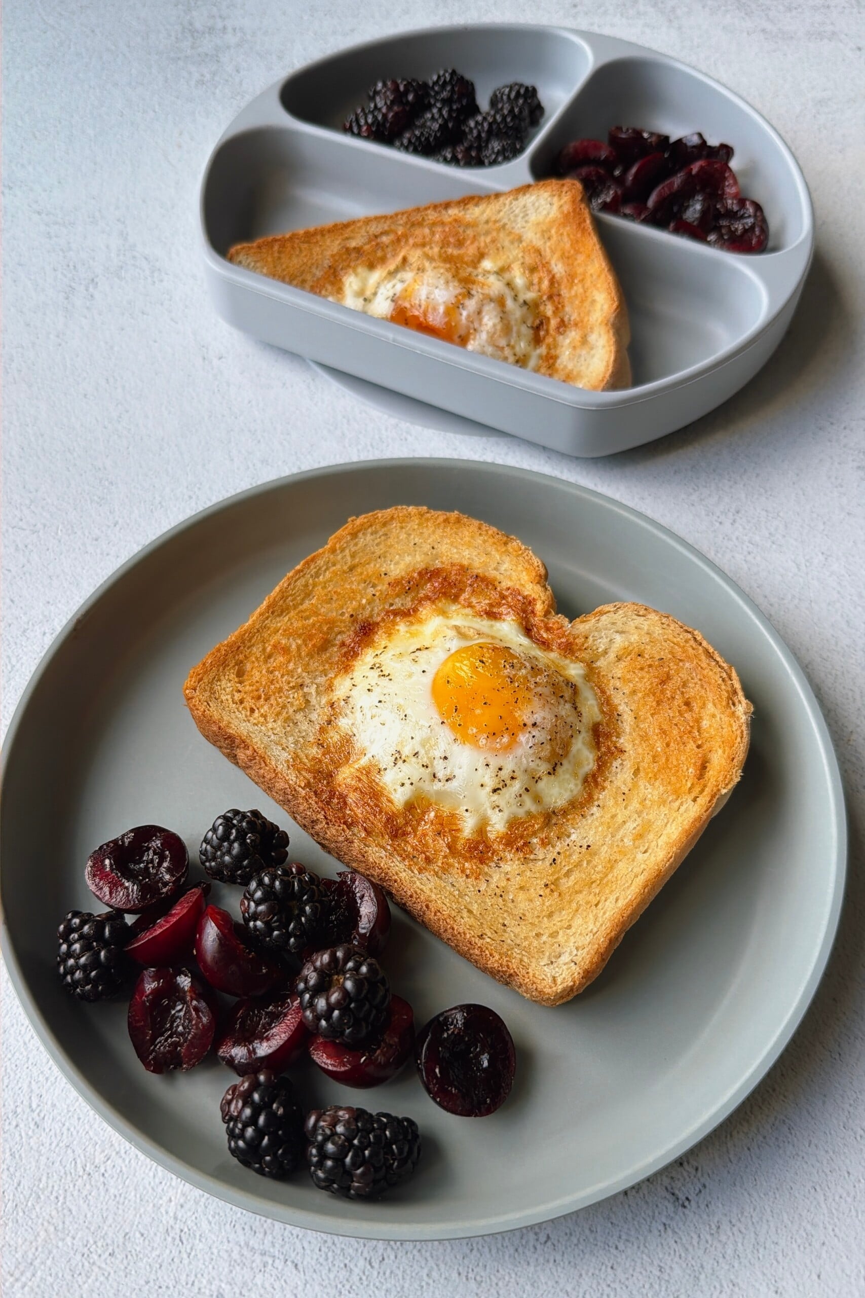 Air fryer egg toast served with blackberries and cherries.