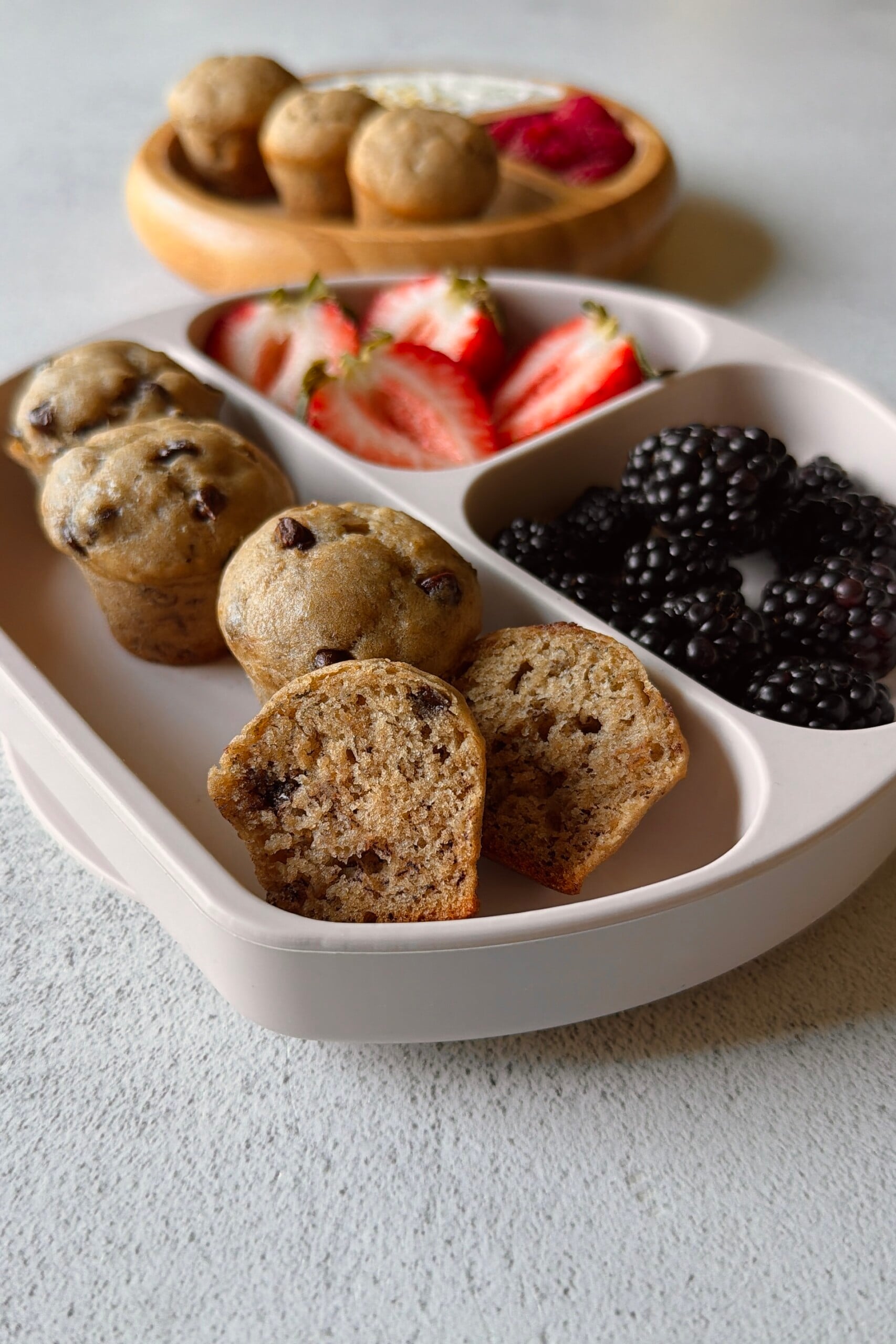 Eggless banana muffins served with berries and yogurt.