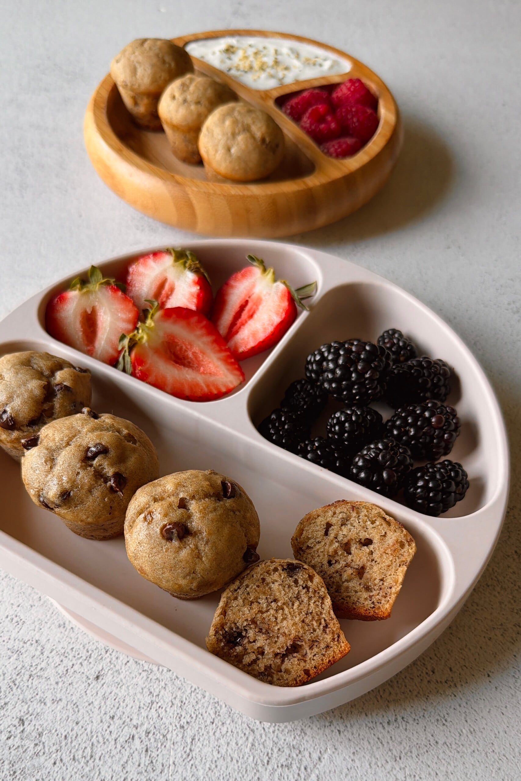 Eggless banana muffins served with berries and yogurt.