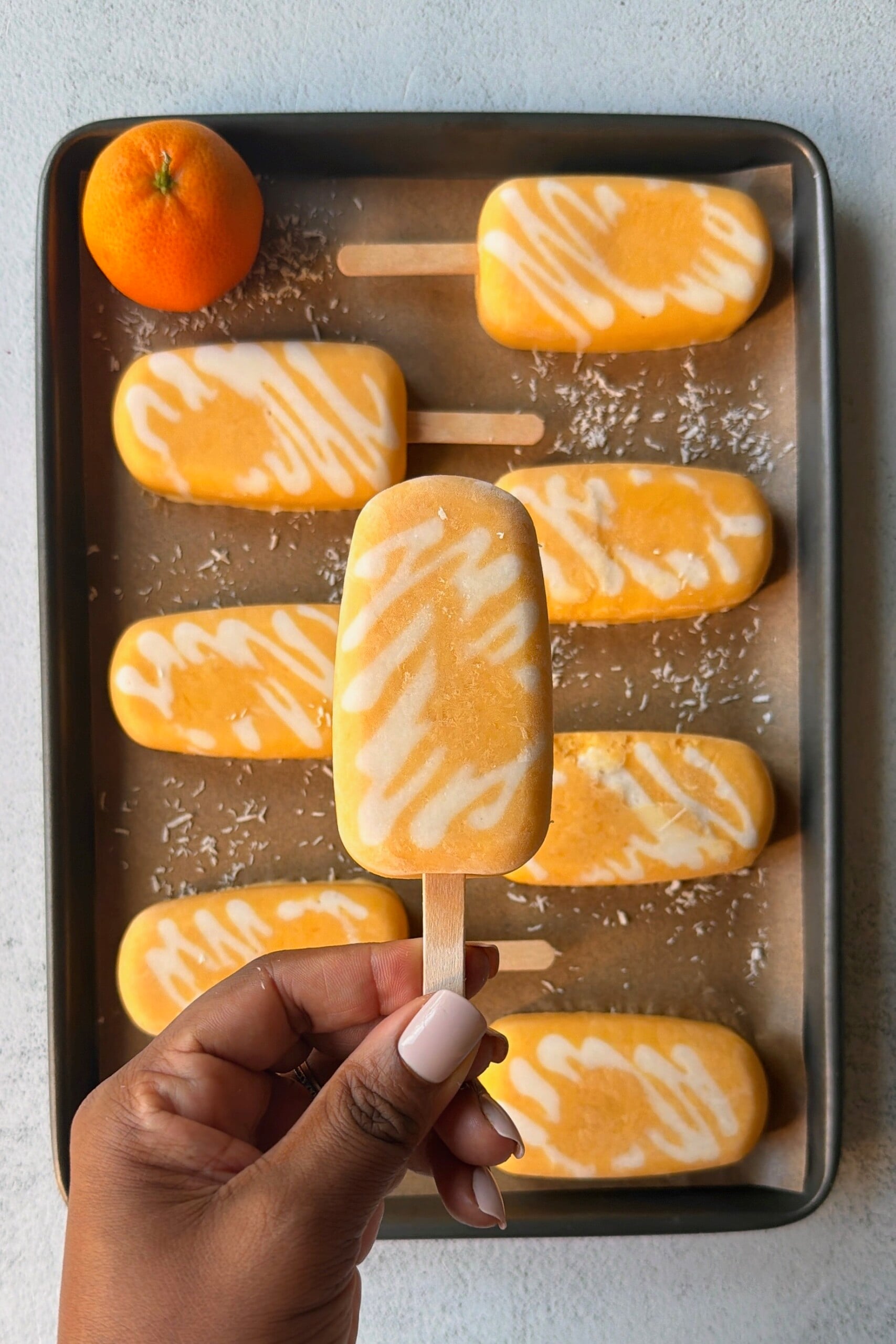 Homemade orange creamsicle popsicles.