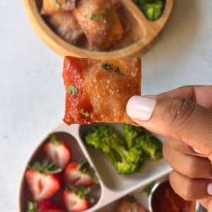 Homemade pizza rolls served with strawberries and broccoli.