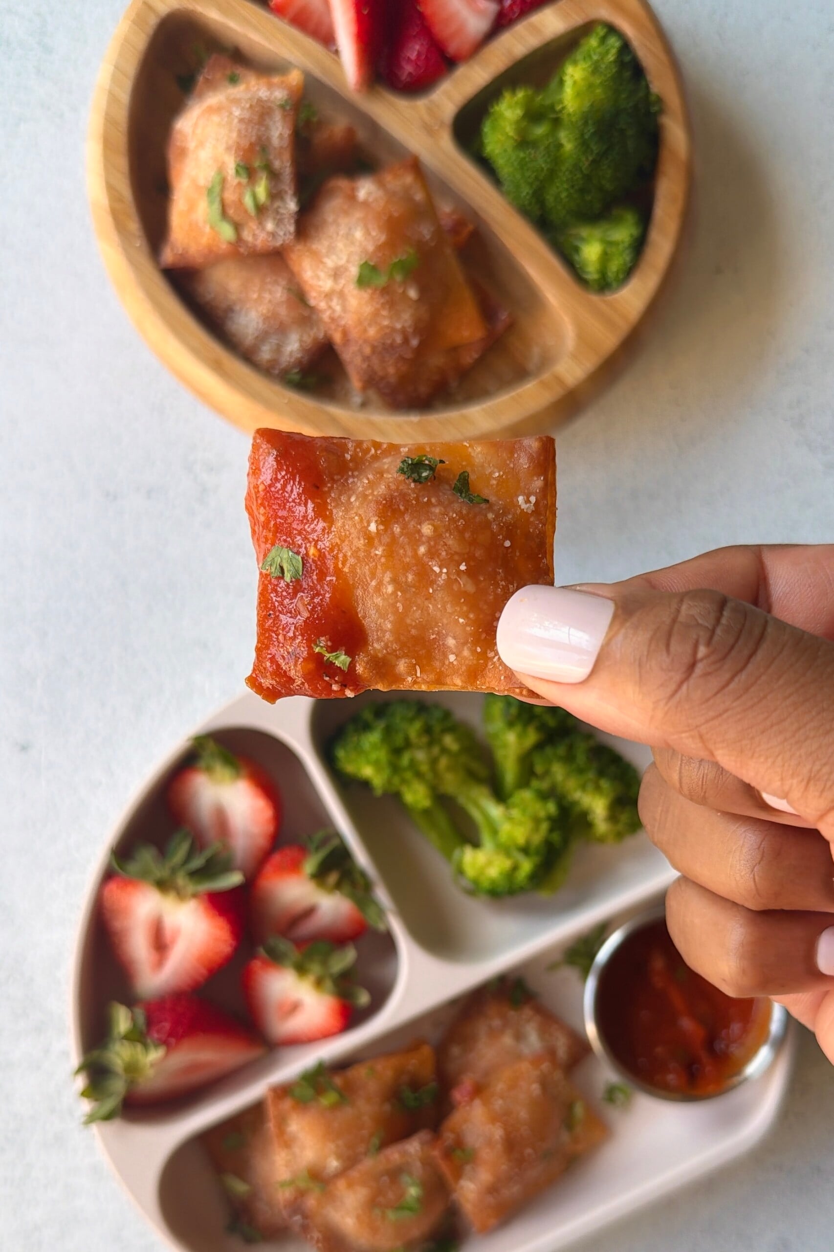 Homemade pizza rolls served with strawberries and broccoli.