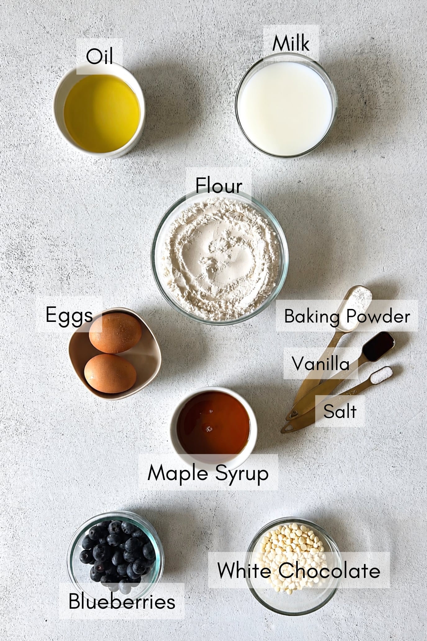Ingredients to make white chocolate blueberry muffins.