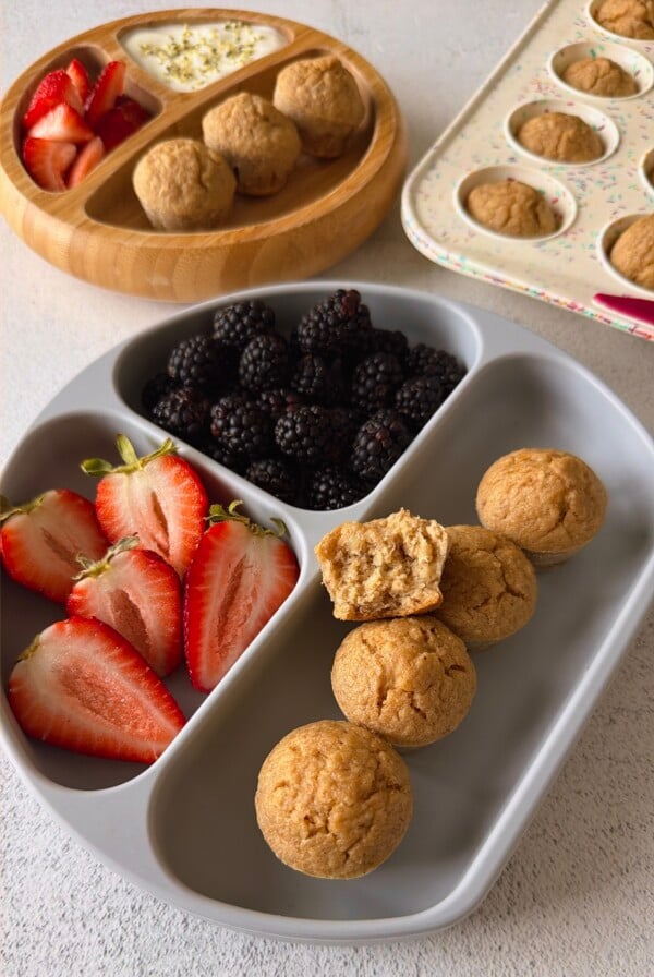 Banana oat flour muffins served with berries and yogurt.