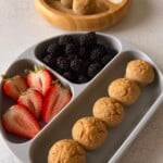 Banana oat flour muffins served with berries and yogurt.