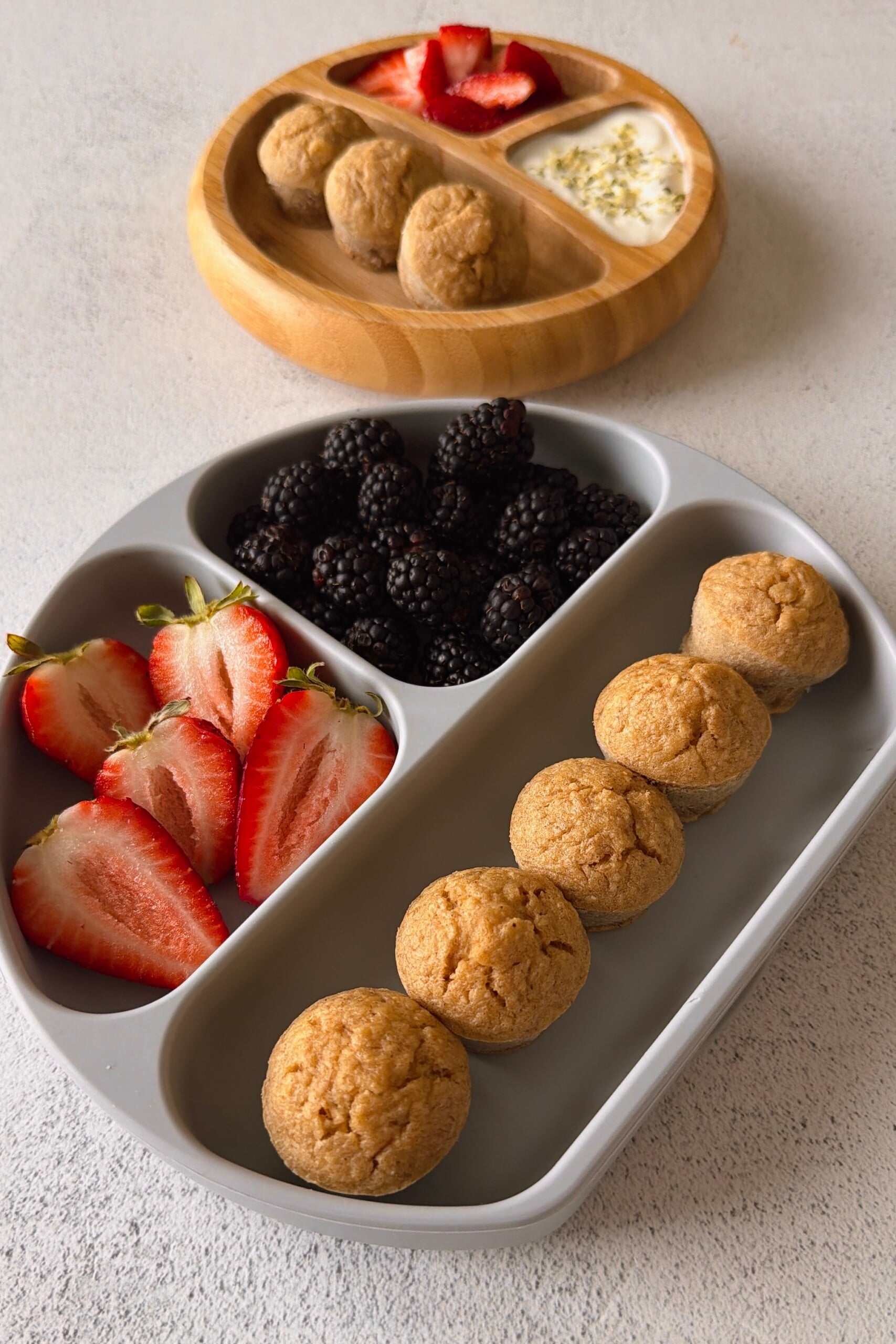 Banana oat flour muffins served with berries and yogurt.