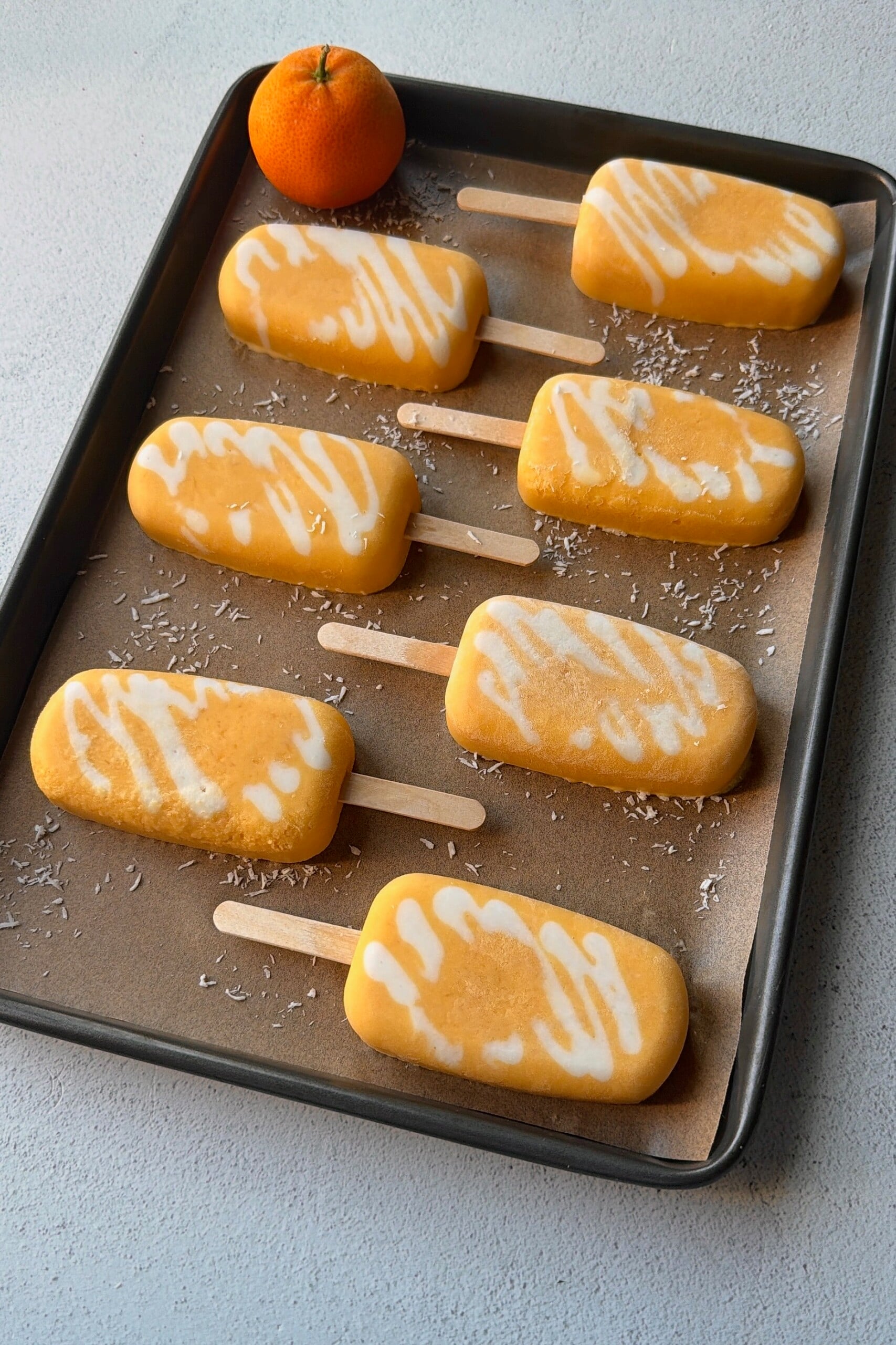 Homemade orange creamsicle popsicles.