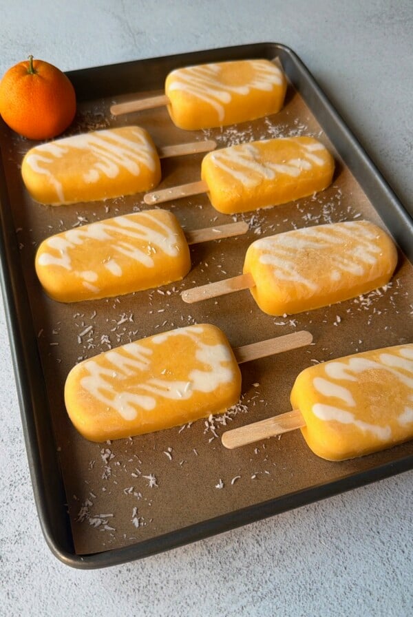Homemade orange creamsicle popsicles.