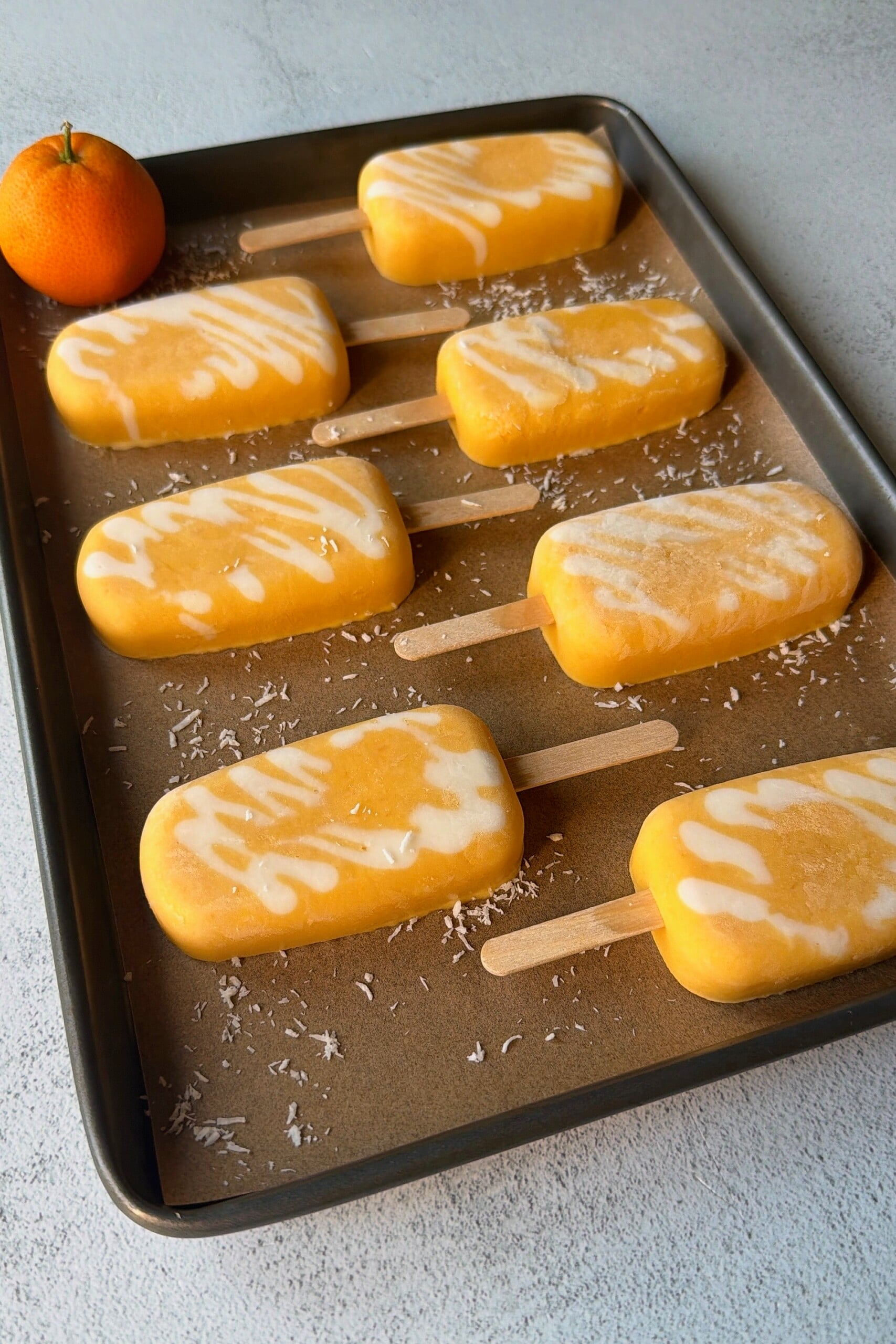 Homemade orange creamsicle popsicles.