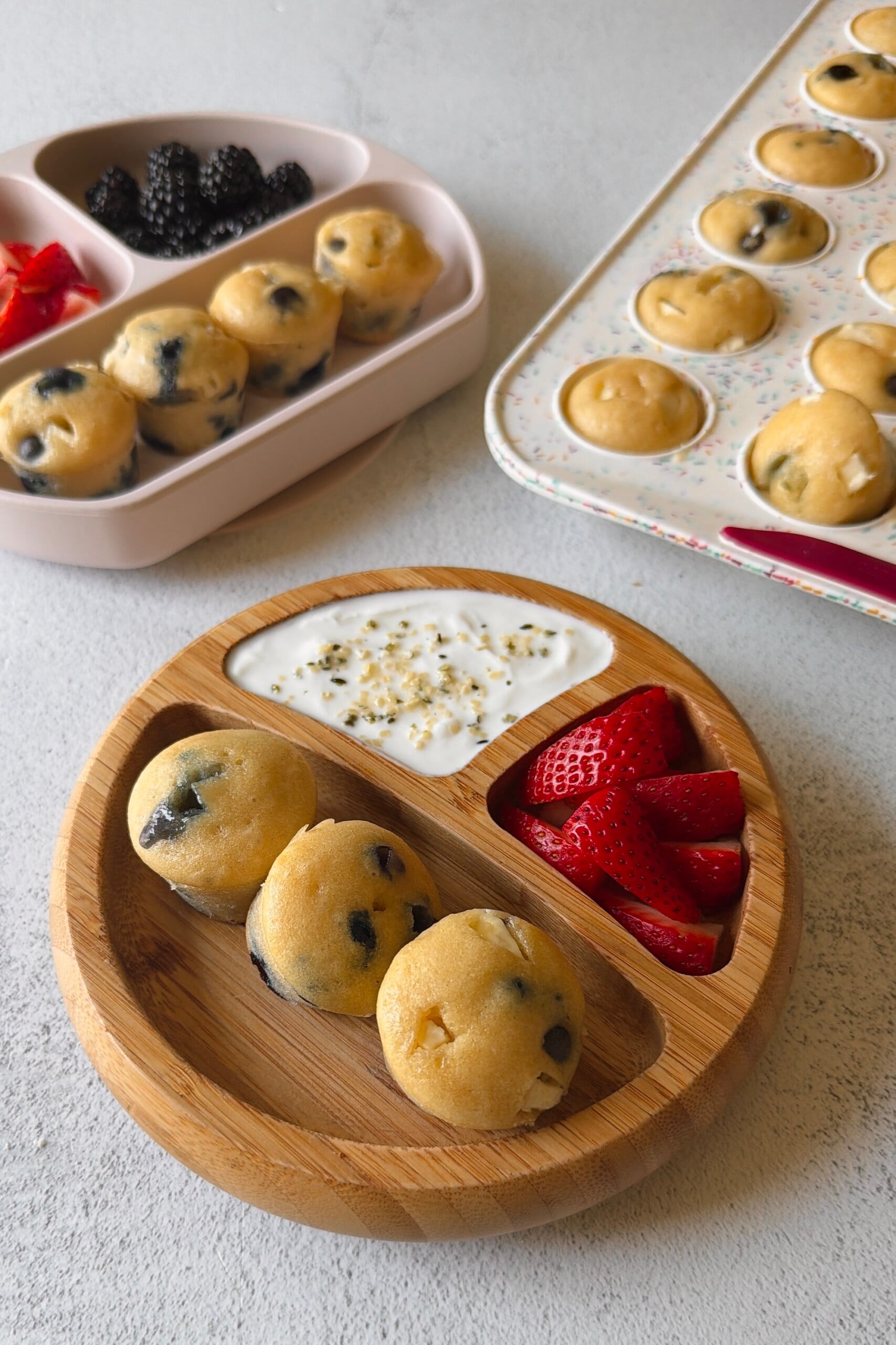 Blueberry and white chocolate muffins served with berries and yogurt.