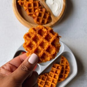 Savory carrot waffles served with a yogurt dip and strawberries.