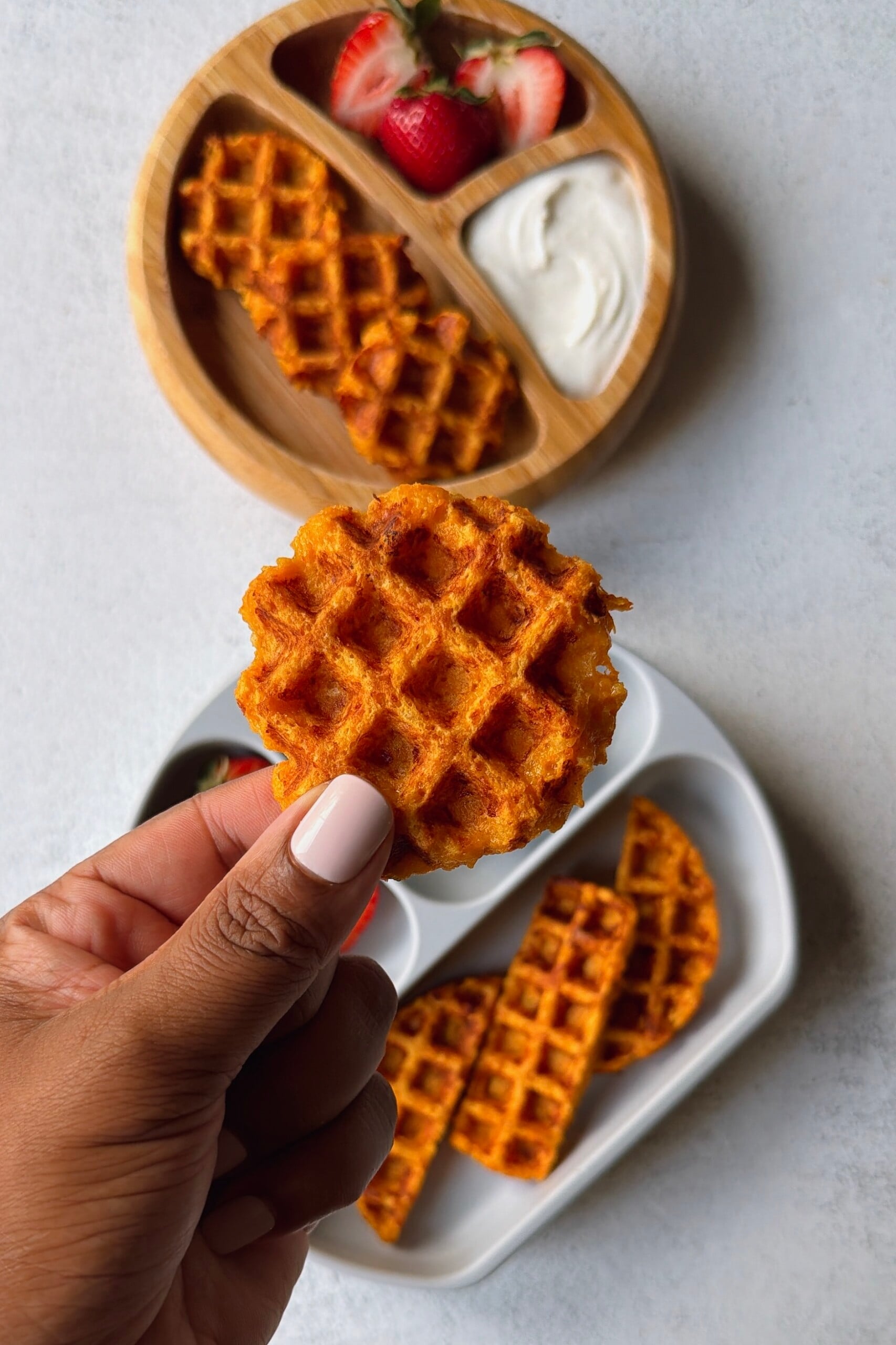 Savory carrot waffles served with a yogurt dip and strawberries.