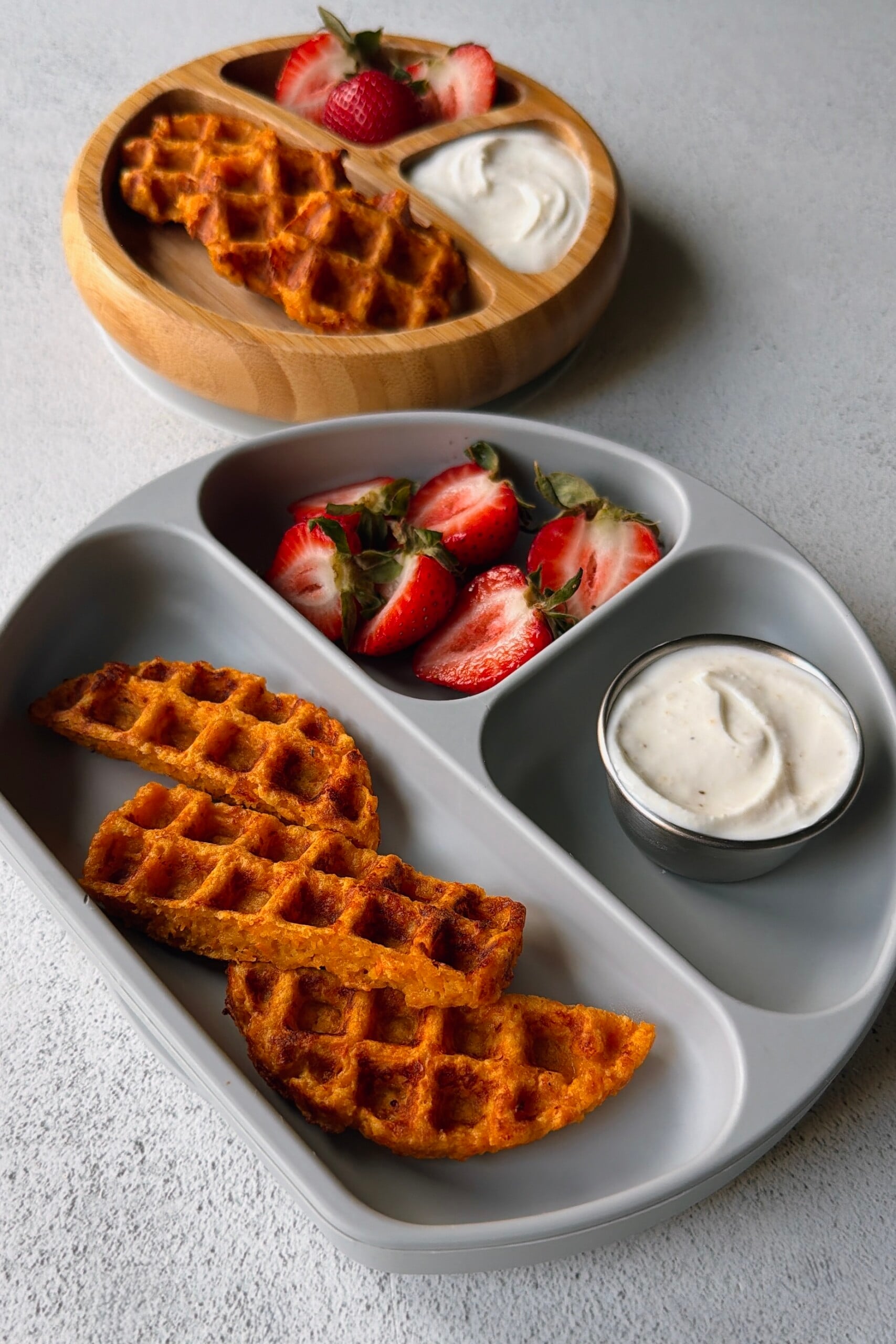 Savory carrot waffles served with a yogurt dip and strawberries.