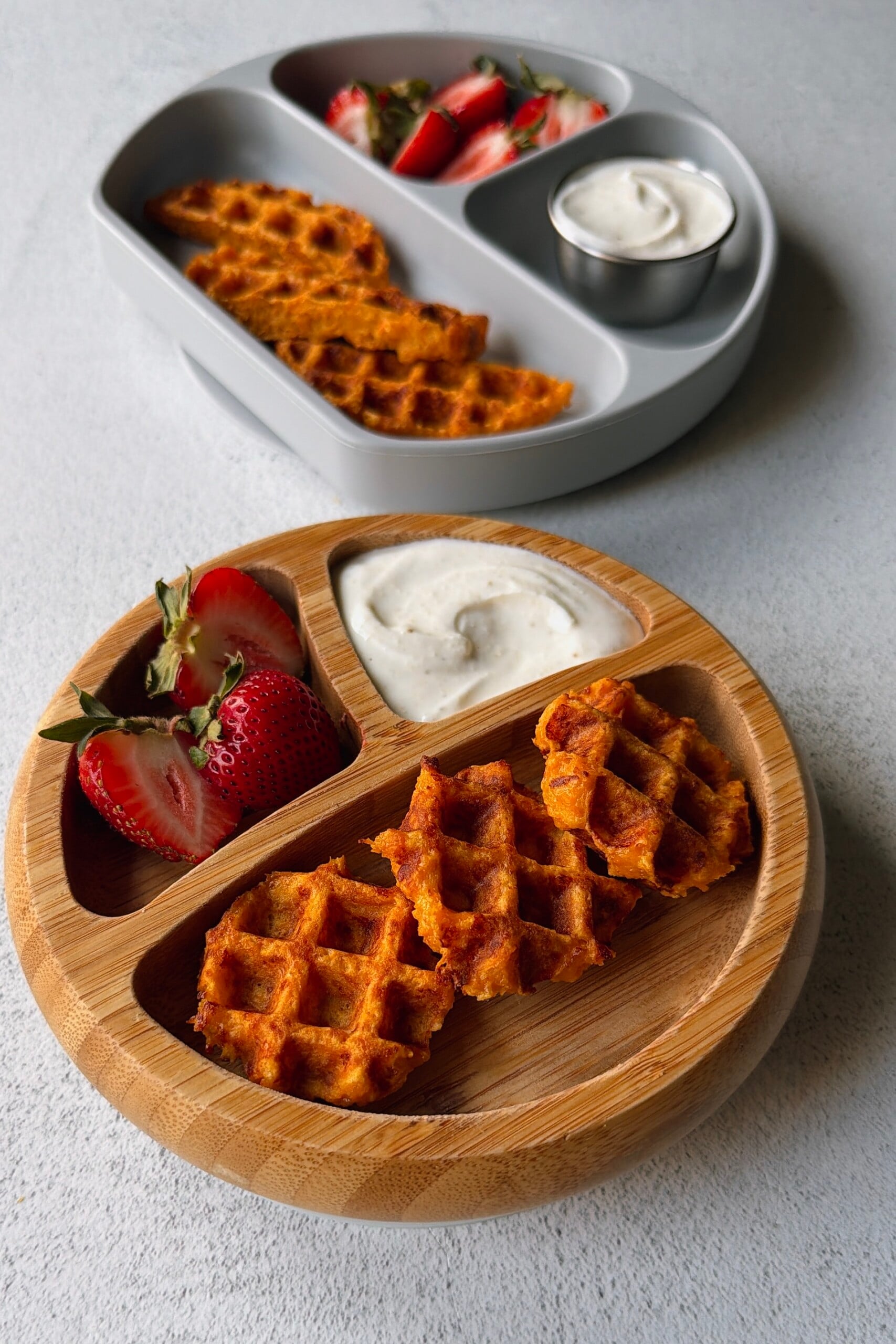 Savory carrot waffles served with a yogurt dip and strawberries.