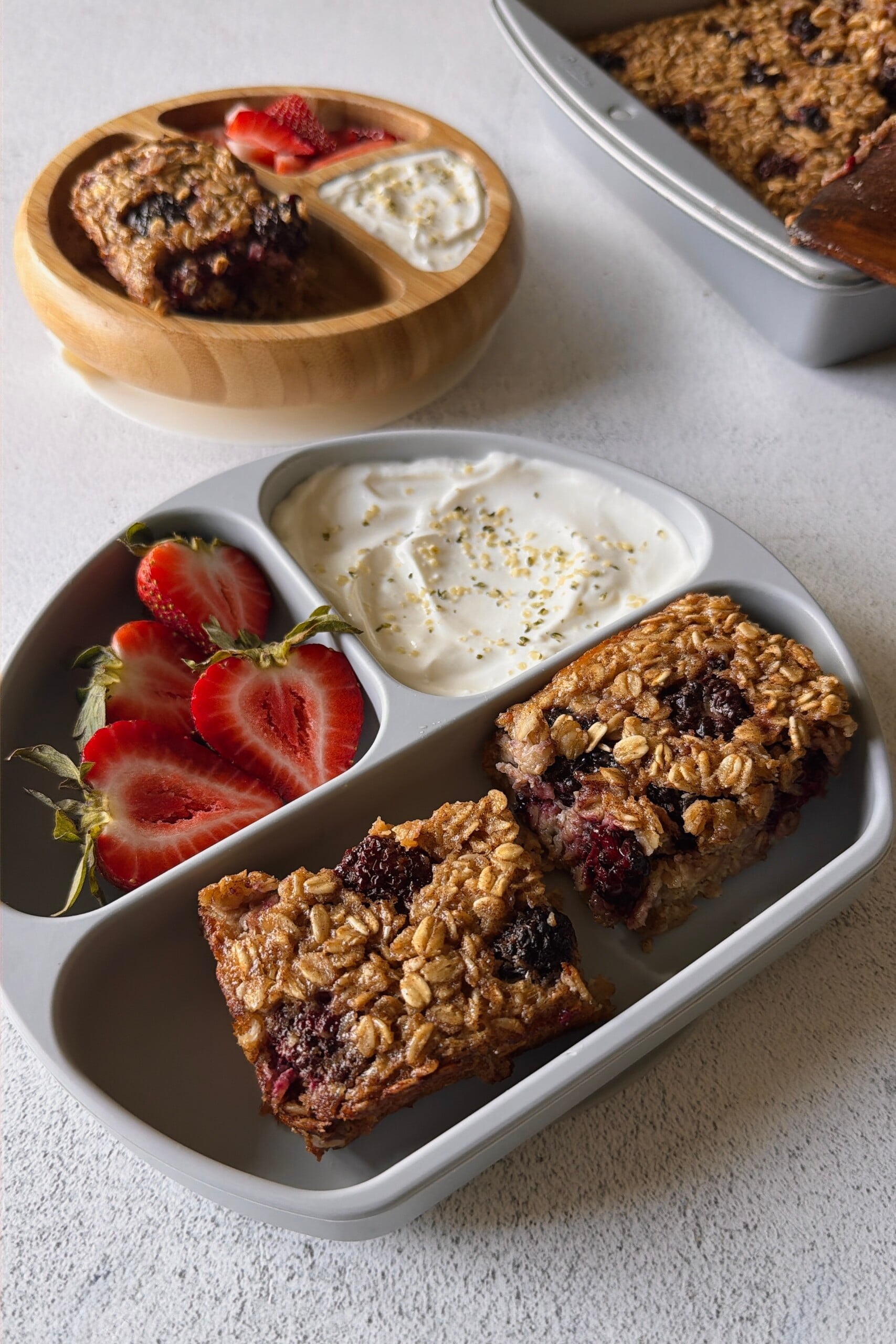 Blackberry baked oats served with strawberries and yogurt.
