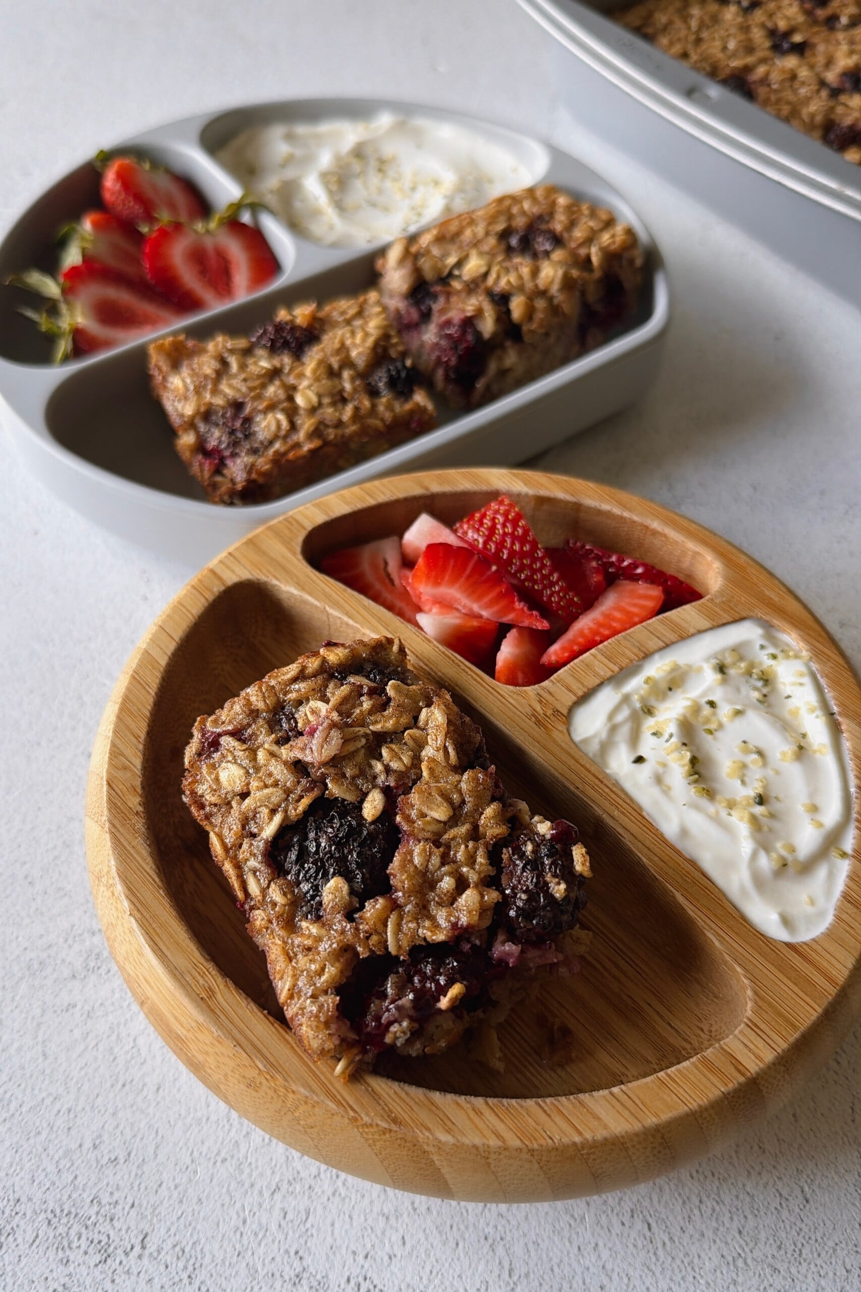 Blackberry baked oats served with strawberries and yogurt.