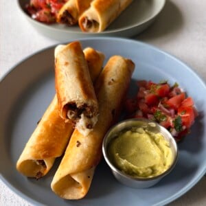 Ground beef taquitos served with pico de gallo and an avocado dip.