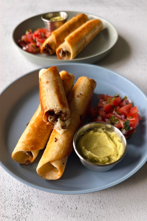 Ground beef taquitos served with pico de gallo and an avocado dip.