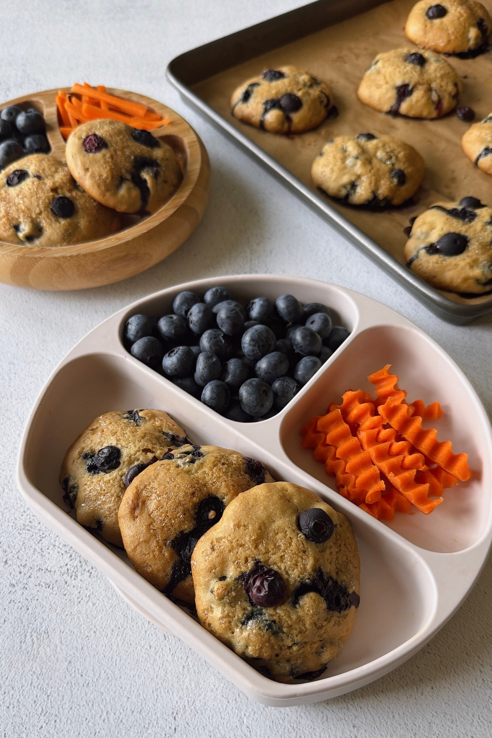 Blueberry muffin tops served with berries and carrots.