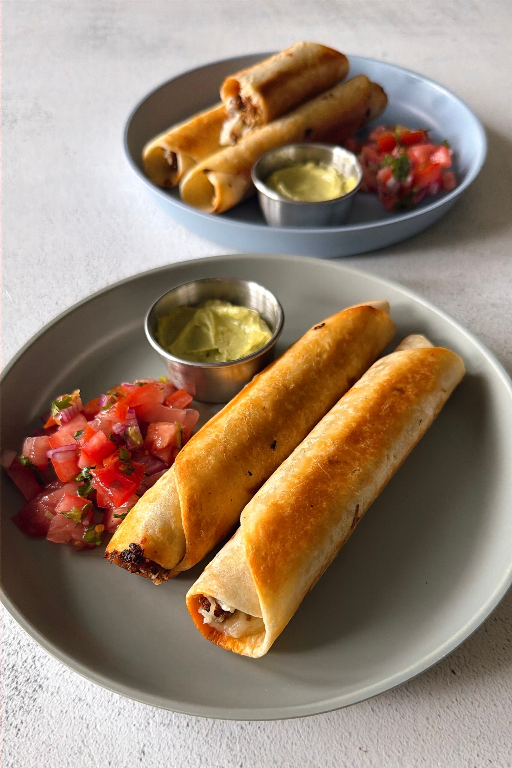 Ground beef taquitos served with pico de gallo and an avocado dip.
