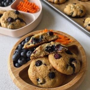 Blueberry muffin tops served with berries and carrots.