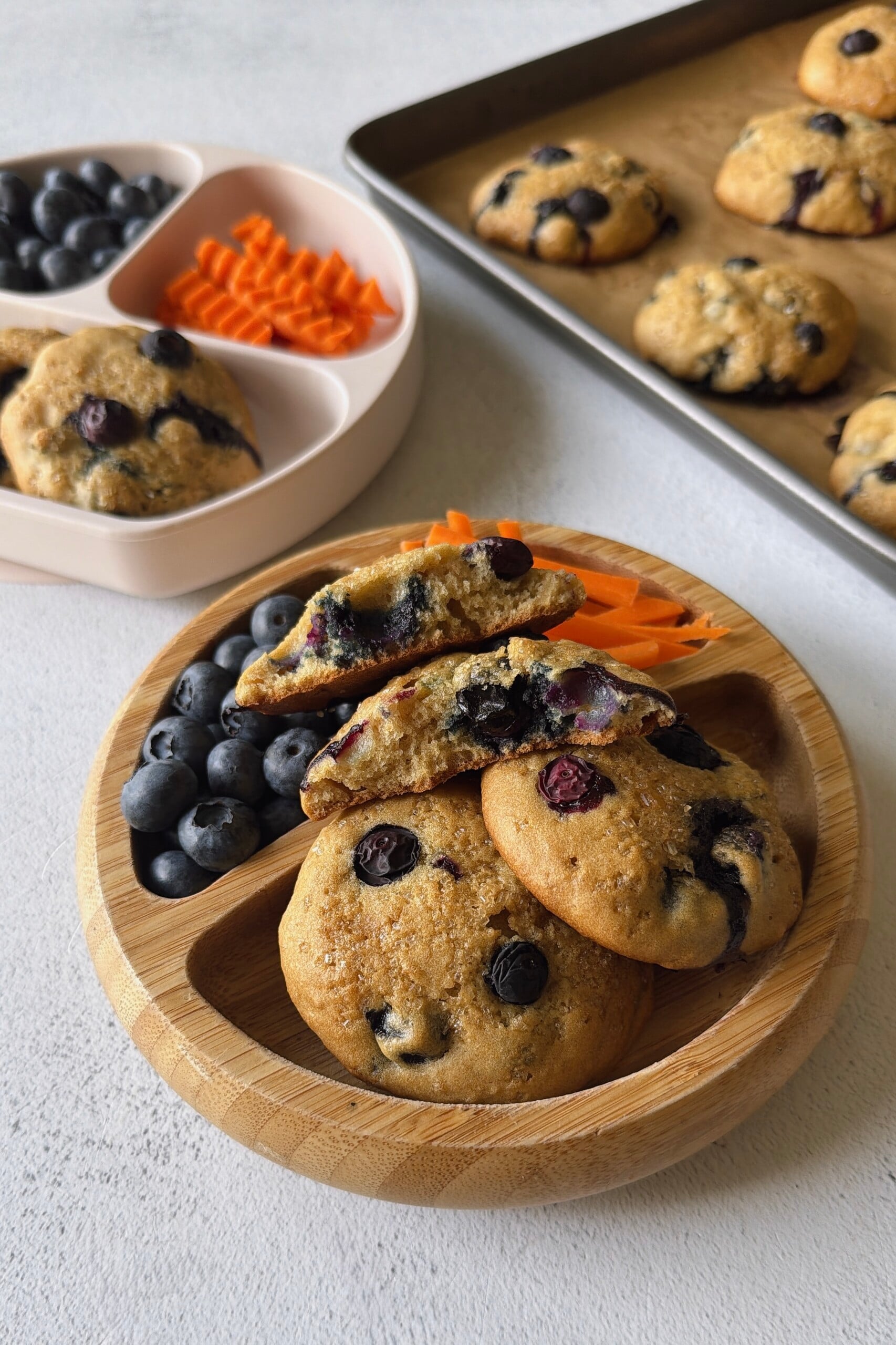 Blueberry muffin tops served with berries and carrots.